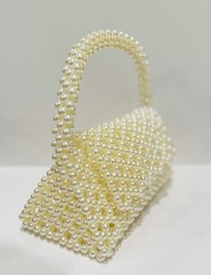 beautiful white pearl purse to elevate your style. fits your phone White Handheld Shoulder Bag With Pearl Handle, Rectangular Evening Bag With Pearl Embroidery For Gift, Rectangular Pearl Embroidery Evening Bag As Gift, White Pearl Evening Bag For Party, Rectangular Pearl Embroidery Evening Bag, Elegant Pearl White Beaded Clutch, Elegant Pouch Clutch With Pearl Handle, Pearl Clutch Evening Bag, White Luxury Clutch With Pearl Handle