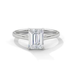 an emerald - cut diamond ring on a white background