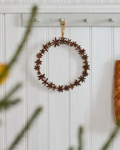 a wreath is hanging on the wall next to a basket