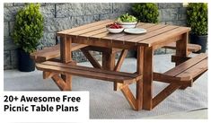 the picnic table is made out of wooden planks and has two bowls of fruit on it