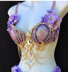 a purple bra with flowers and chains attached to it