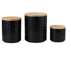 three black and natural wood stools with carved designs on the top one is round