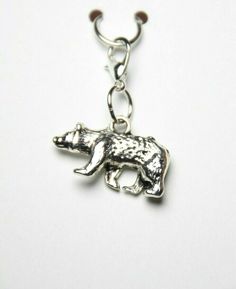 a silver bear charm on a white background