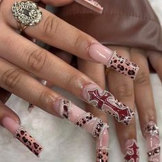 a manicure with leopard print on it and pink nail polish, is shown in the foreground