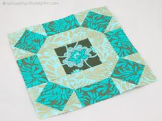 a blue and green square with flowers on it