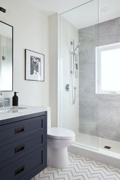 a bathroom with a toilet, sink and shower