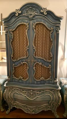 an old fashioned armoire with curtains on the front and side panels, in blue