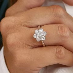 a woman's hand with a diamond ring on it