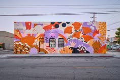 a colorful building painted with flowers on the side