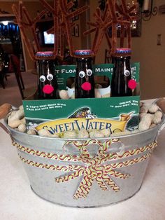 four bottles of weilweiser beer in a bucket with candy canes and reindeer noses