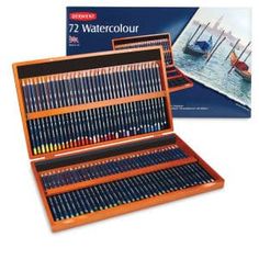 a wooden box filled with colored pencils and an image of boats in the water