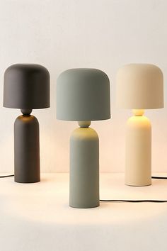 three different colored lamps sitting next to each other