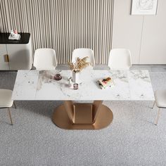 a white marble dining table with chairs around it