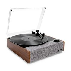 the record player is sitting on top of a wooden stand with an electronic device attached to it