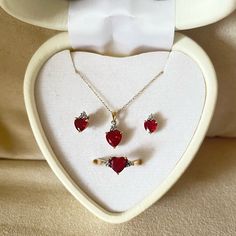 This Is A Heart-Shaped Jewelry Set. This Set Includes A Pair Of Beautiful Ruby Red Earrings, A Gorgeous Ruby Red Heart-Shaped Necklace On A Gold Chain And A 10k Gold Ring Topped With A Heart-Shaped Ruby With Diamonds. Red Heart Cut Jewelry With Diamond Accents, Red Heart Cut Diamond Accented Jewelry, 14k Gold Heart Cut Red Jewelry, Red 14k Gold Heart Cut Jewelry, Red Heart Cut Diamond Accent Jewelry, Red Heart-shaped Hallmarked Jewelry, Red Hallmarked Jewelry For Valentine's Day, Ruby Jewelry Necklaces Gold, Red Heart Jewelry