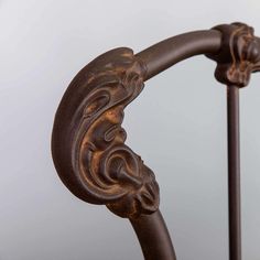 an ornate iron bed frame with decorative carvings on the rails and headboard, against a white background