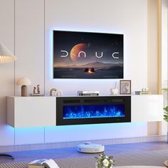 a living room with a large television mounted on the wall and blue flames in the fireplace