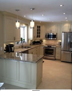 a large kitchen with stainless steel appliances and granite counter tops, along with marble flooring