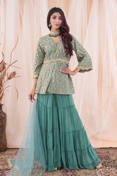 Aqua jade green peplum top with floral patterns, tasseled placket and placed pearl, cutdana, sequins and zari zardozi scalloped embroidery. Comes with tiered sharara and sequin spread dupatta. - Aza Fashions Elegant Green Tops For Eid, Festive Green Peplum Sharara, Festive Peplum Sets With Ruffles, Green Bollywood Sharara With Ruffles, Green Palazzo Set With Unstitched Blouse For Reception, Green Ruffled Sharara For Wedding, Festive Green Tops With Dupatta, Festive Green Top With Dupatta, Green Saree Set With Ruffles