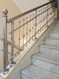 there is a set of stairs leading up to the second floor with railings and handrails