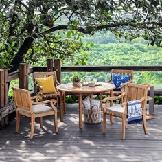 an outdoor table and chairs on a deck