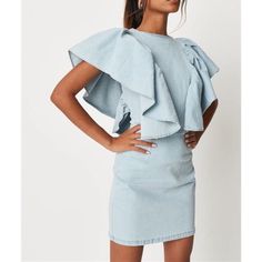 Short Extreme Ruffle Sleeve Denim Dress In A Stretchy Fabric With An Exposed Back Zip. Regular Fit Mini - Sits Mid Thigh 73% Cotton 25% Polyester 2% Elastane Chic Denim Dress With Frayed Hem In Mini Length, Fitted Blue Denim Dress With Ruffle Hem, Chic Denim Mini Dress With Frayed Hem, Fitted Denim Dress With Ruffle Hem, Spring Denim Dress With Ruffle Hem, Light Blue Fitted Dress With Ruffle Sleeves, Medium Wash Denim Dress With Ruffles, Denim Blue Ruffled Mini Dress, Denim Blue Mini Dress With Ruffles