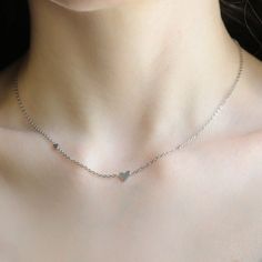 Elegant and timeless, this sterling silver necklace is the perfect blend of sophistication and simplicity. Crafted from high-quality 925 sterling silver, it features a delicate chain that drapes gracefully around the neck. The necklace shines with a polished finish, offering a versatile accessory that complements both casual and formal attire. Its minimalist design makes it ideal for layering or wearing solo as a statement piece. Whether you're dressing up for an evening out or adding a touch of Sterling Silver Delicate Chain Necklace For Anniversary, Anniversary Sterling Silver Delicate Chain Necklace, Delicate Sterling Silver Heart Necklace With Clavicle Chain, Silver Stainless Steel Necklace For Valentine's Day, Silver Minimalist Clavicle Chain Charm Necklace, Silver Heart Pendant Necklace With Delicate Chain, Delicate Silver Charm Necklace With Adjustable Chain, Minimalist Silver Charm Necklace With Clavicle Chain, Minimalist Sterling Silver Chain Necklace For Anniversary