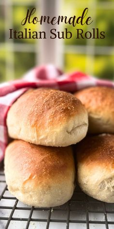 homemade italian sub rolls stacked on top of each other in front of a red and white towel