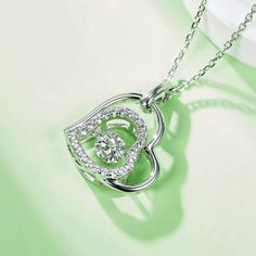 An eye-catching round moissanite dances with ease at the center of this appealing women's necklace, expressing your unstoppable love. Additional round gem set in sterling silver frame the center. Features Moissanite was originally found in meteorites(Chemical name: Silicon Carbide). It was first discovered in 1893, while a scientist was examining meteor samples from a crater in Arizona. After many years, the experts has been recreated moissanite in the laboratory, that make the gemstone with fri Round Halo Design Jewelry For Valentine's Day, Valentine's Day Moissanite Jewelry With Center Stone, Cubic Zirconia Necklace With Center Stone For Gift, Sterling Silver Halo Jewelry For Valentine's Day, Sterling Silver Jewelry With Halo Design For Valentine's Day, Silver Round Necklace With Center Stone, Valentine's Day Cubic Zirconia Jewelry With Halo Design, Silver Jewelry With Heart Cut Halo Design, Silver Heart Cut Jewelry With Halo Design