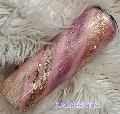 pink and gold glitter tumbler on white fur