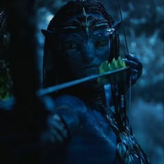 a woman dressed as avatar from avatar holding a bow and arrow in front of her face