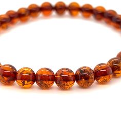 Boho-Chic Amber Bead Bracelet from Super Silver, perfect for adding a touch of elegance to any outfit. Handcrafted with genuine Baltic amber beads, this bracelet is not only stylish but also believed to possess healing properties. Amber Round Bracelets As Gifts, Amber Round Bracelets As A Gift, Round Amber Bracelet As Gift, Amber Beaded Bracelets With Polished Beads As Gift, Elegant Amber Beaded Bracelets With Round Beads, Brown Polished Beaded Bracelets As Gift, Amber Stretch Bracelet With 8mm Beads As Gift, Amber Beaded Bracelets As Gift, Amber Beaded Bracelets For Gift