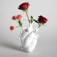 there is a vase with roses in it