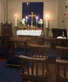 the interior of a church with pews and candles