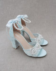 "Fun and flirty lace block heel sandals with pearl appliques. Perfect for weddings, parties, or any special occasion. DETAILS: HEEL HEIGHT: 3.6 inches COLORS AVAILABLE: Ivory, White and Light Blue UPPER: Synthetic upper and lining MATERIALS: Manmade outsole STYLE NAME: FAITH SIZE FIT: RUNS LARGE Not sure of which size to purchase? Shoes measurements are as follow: (Please note measurements taken the length of inside of shoe from toe to heel) SIZE 5 - 9.25\" SIZE 6 - 9.50\" SIZE 7 - 9.75\" SIZE 8 Evening Open Toe Lace Sandals, Open Toe Lace Wedding Shoes For Party, Formal Lace High Heel Sandals, Elegant Lace Sandals For Formal Occasion, Blue Open Heel Wedding Shoes, Lace Block Heel Party Shoes, Lace Block Heel Party Heels, Lace Block Heels For Party, Party Lace Block Heels