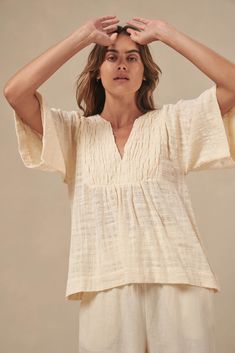 The Tulum top from Australian brand Little Lies is a perfect staple for spring/summer. Features pleated detail on the front, a flattering square sleeve and a v-neckline. This gorgeous top is an oversized fit that can be paired with your favorite pants or shorts. Semi-sheer. Materials: 100% Cotton Care: Wash with like colors; cold gentle machine wash; do not bleach; lay flat to dry; warm iron; do not tumble dry. Size Info: Model is 5'8" and is wearing a size S; relaxed fit Size Guide | Shipping Policy