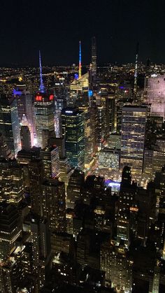 an aerial view of new york city at night from the top of the empire building