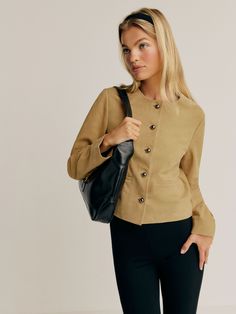 Layer up. Shop the Veda Reed Leather Jacket from Reformation, a collarless jacket with a button front and front pockets. Elegant Leather Jacket For Workwear With Pockets, Versatile Button Closure Outerwear For Work, Versatile Fall Business Blazer, Versatile Business Blazer For Fall, Workwear Leather Jacket With Stand Collar And Pockets, Versatile Fall Blazer For Business, Versatile Fall Outerwear With Buttons, Chic Outerwear With Button Closure And Stand Collar, Workwear Outerwear With Stand Collar And Button Closure