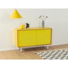 Unique chest of drawers from the 1950s. Body in walnut veneer with two colored glass sliding doors in yellow, a shelf and new square steel feet in white. The surfaces were coated with yellow Formica.  Quality features:    very good workmanship   high quality materials   Made in Germany Glass Sliding Doors, Vintage Chest Of Drawers, Vintage Chest, Walnut Veneer, Sliding Glass Door, Chest Of Drawers, A Shelf, Sliding Doors, The 1950s