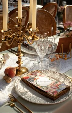 an elegant table setting with candles and place settings