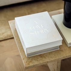 a stack of books sitting on top of a wooden table