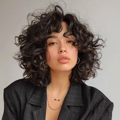 The Shoulder-Grazing Shag Bob Curly Haircut Medium Length, Curly Shag Bob, Shaggy Short Hair Curly, Shag Haircut Curly Hair, Short Layered Curly Haircuts, Haircuts Thick Curly Hair, Face Framing Bangs Curly Hair, Curly Hair Bun Styles, Curly Hair Bob Haircut