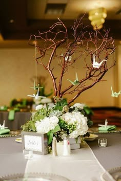 the centerpieces are decorated with branches and flowers