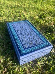 a blue and white book laying in the grass