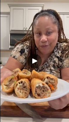 a woman sitting at a table with a plate of food