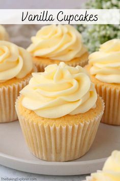 vanilla cupcakes with white frosting on a plate