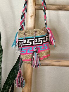 Original mini double-threaded handmade handbag with design from Colombia by Wayuú people. Festival Crochet Bag With Braided Handles, Crochet Bucket Bag With Weaving For Vacation, Vacation Bucket Crochet Bag With Weaving, Weaving Crochet Bucket Bag For Vacation, Rectangular Crochet Bag With Braided Handles For Festivals, Rectangular Woven Straw Bag For Festivals, Pink Handwoven Crochet Bucket Bag, Multicolor Handwoven Bucket Crochet Bag, Festival Handwoven Crochet Pouch Bag