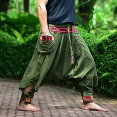 "Green Tribal pants, Hmong pants, Traditional Thai pants, Harem pants, Unisex pants Tribal pants is very comfortable and easy to wear, Unisex for Men and Women Every Detail of Tribal pants is made by Thai Craftsmanship. Tribal pants is inspired by Tribal in the North of Thailand or Hmong. Redesign for easy to wear and comfy. Great for many occasion activities like Chilling time, Casual wear, Relax time. This item is made of high-quality cotton in the north of Thailand. Printed with Special techn Traditional Spring Bottoms With Pockets, Traditional Style Baggy Pants For Spring, Traditional Baggy Pants For Spring, Traditional Baggy Bottoms For Spring, Traditional Wide Leg Pants With Pockets, Traditional Wide-leg Pants With Pockets, Traditional Spring Pants With Pockets, Traditional Green Bottoms For Spring, Traditional Bottoms With Pockets In Long Pants Style