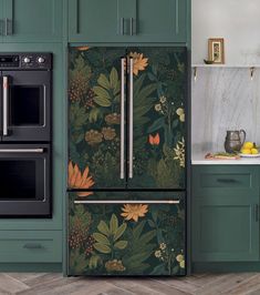 a kitchen with green painted cabinets and floral wallpaper on the refrigerator, stove and oven