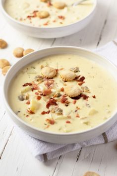 two white bowls filled with soup on top of a table